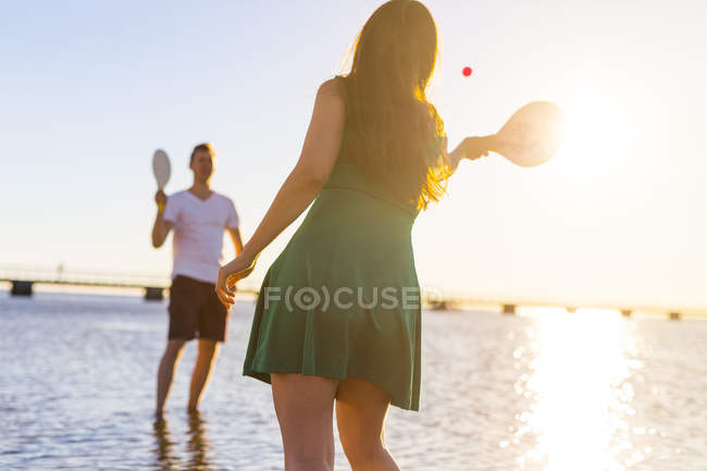 Couple playing with racquet and ball — Stock Photo