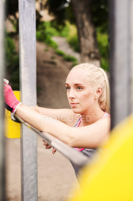 Young woman relaxing on exercise equipment — Stock Photo