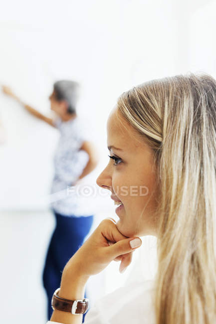 Student with professor teaching in background — Stock Photo