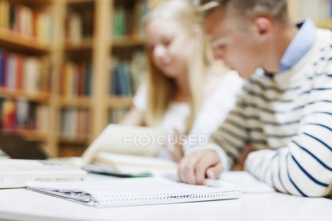 University students studying in library — Stock Photo