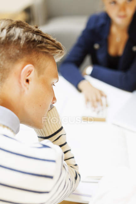 Rear view of male student studying — Stock Photo