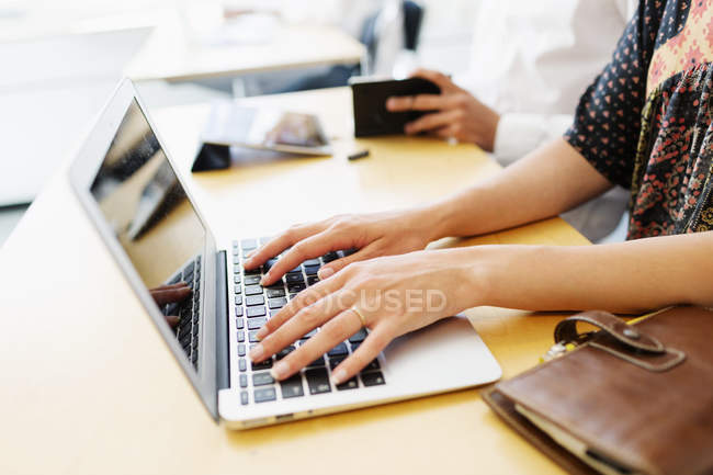 Student with laptop in classroom — Stock Photo