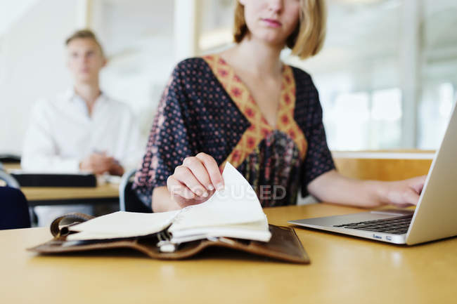 Student with laptop and notebook — Stock Photo