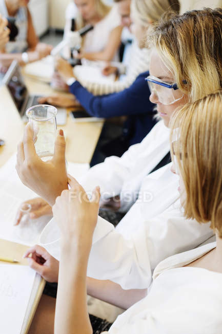 Female students performing science experiment — Stock Photo