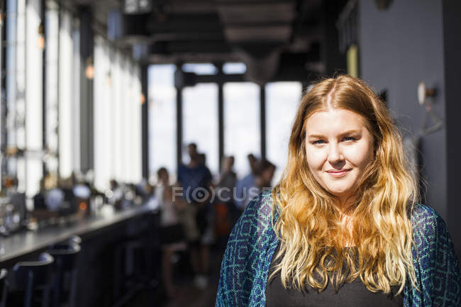 Portrait of young woman in restaurant — Stock Photo
