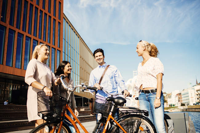 Friends with bicycles standing outside — Stock Photo