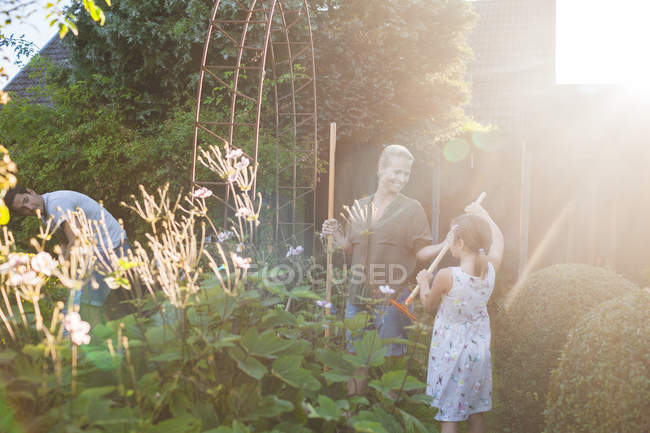 Happy family gardening together — Stock Photo