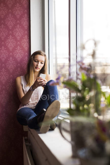 Teenage model using smartphone — Stock Photo