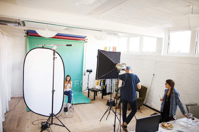 Fotografo con assistente e modella in studio — Foto stock