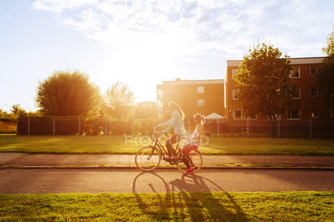 Sporty women riding bicycle — Stock Photo