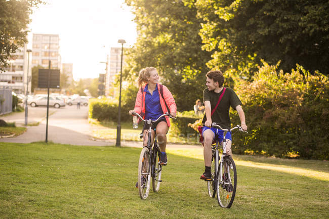 Girl and boy riding bicycles — Stock Photo