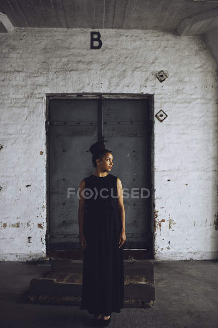 Young woman at old factory — Stock Photo