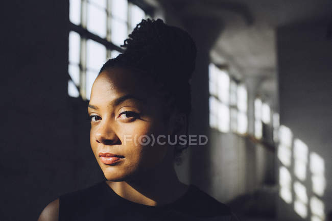 Young woman in old factory — Stock Photo