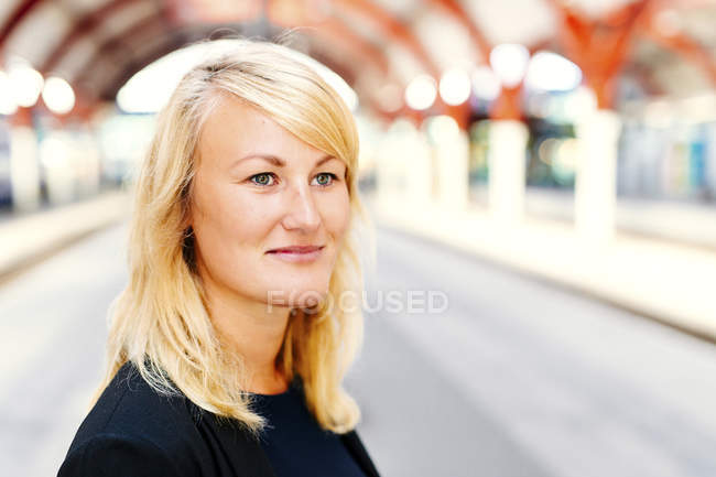 Businesswoman looking away at railroad station — Stock Photo