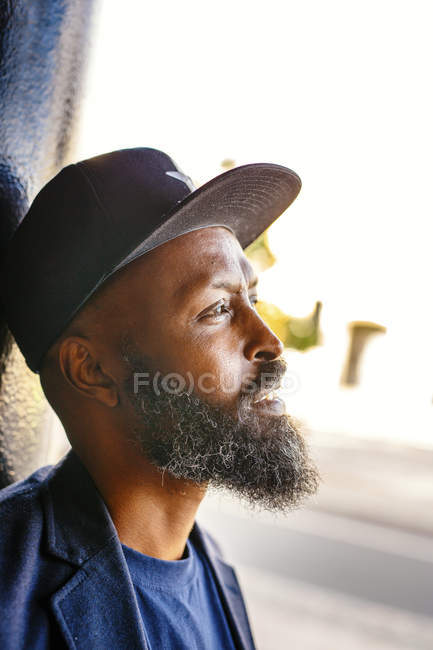 Thoughtful man leaning on column — Stock Photo