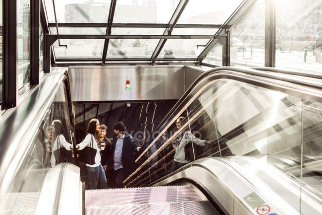 Business people on escalator — Stock Photo