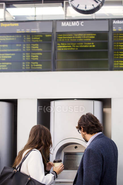 Коллеги по бизнесу используют билетные автоматы — стоковое фото