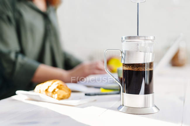 Cafeteira na mesa com empresária — Fotografia de Stock