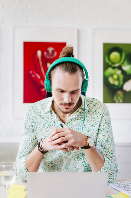 Serious businessman wearing headphones — Stock Photo