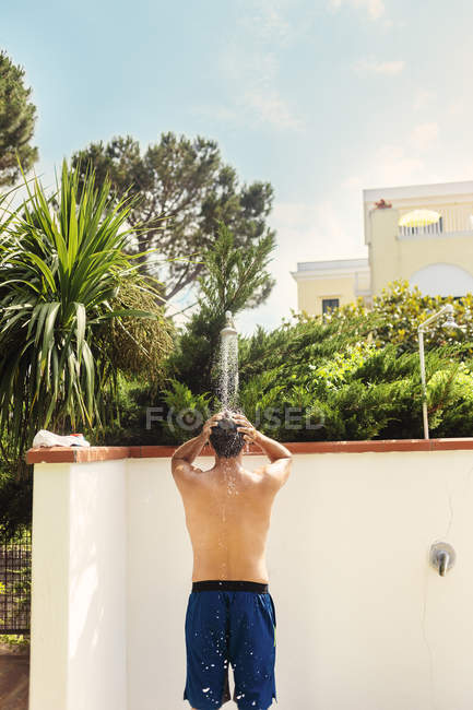 Man bathing under shower — Stock Photo