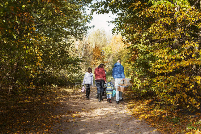 Parents with children walking on footpath — Stock Photo