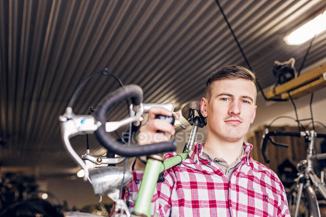 Mechaniker trägt Fahrrad — Stockfoto