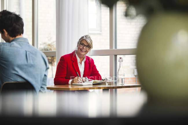 Happy businesswoman looking at colleague — Stock Photo