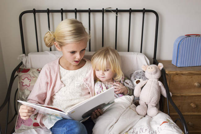 Girls reading book — Stock Photo