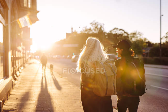 Teenage friends walking on footpath — Stock Photo