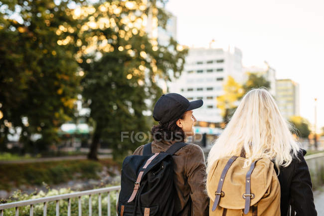 Friends walking on footpath — Stock Photo