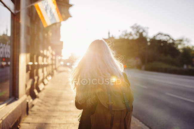 Teenage girl walking on footpath — Stock Photo