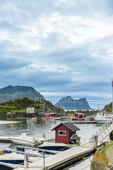 Harbor by mountains against sky — Stock Photo