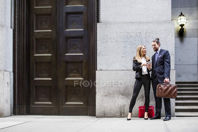 Businessman and woman looking at smartphone — Stock Photo