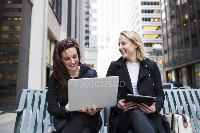 Colleagues using laptop — Stock Photo