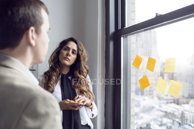 Businesswoman planning with male colleague — Stock Photo