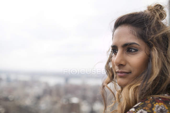 Thoughtful woman looking at city view — Stock Photo