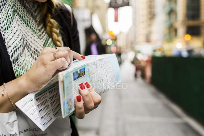 Woman holding map — Stock Photo