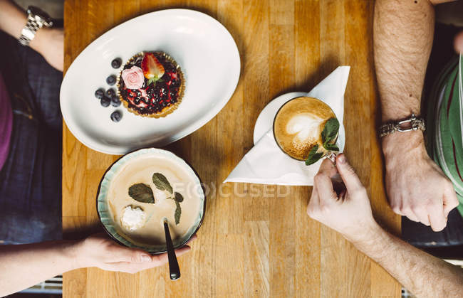 Two men having dessert and coffee — Stock Photo