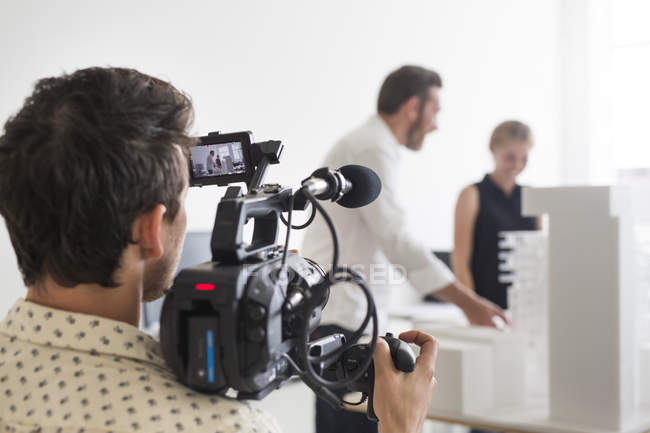Photographer video recording business people — Stock Photo
