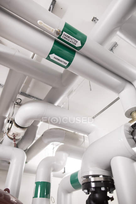 Pipes in factory interior — Stock Photo
