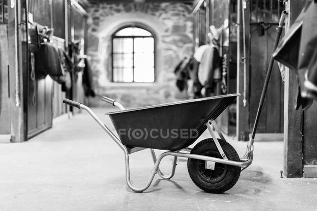 Wheelbarrow in stable, selective focus — Stock Photo