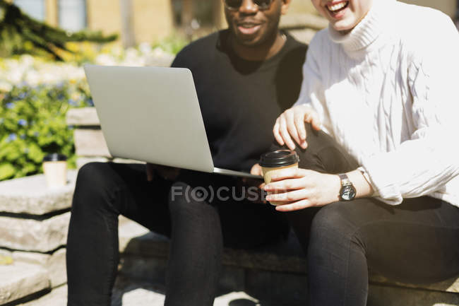 Man with laptop on steps — Stock Photo