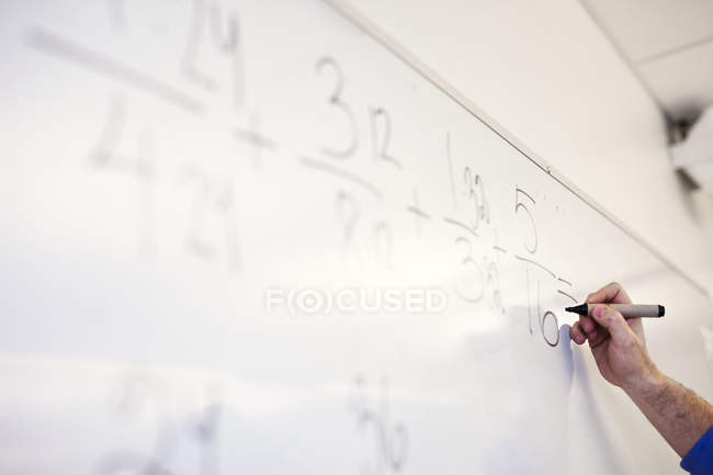 Teacher solving mathematical equation — Stock Photo
