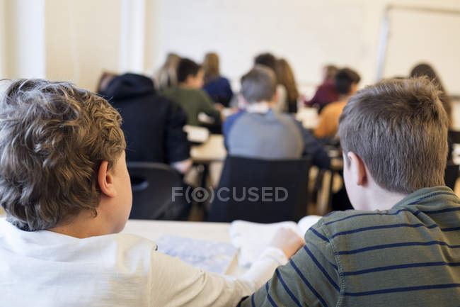 Crianças em idade escolar sentadas em sala de aula — Fotografia de Stock