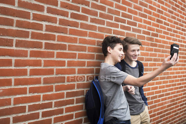Schoolboys taking selfie with mobile phone — Stock Photo