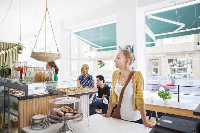 Mid adult woman waiting at cafe — Stock Photo