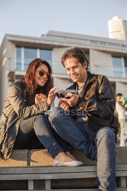 Young couple watching photographs — Stock Photo