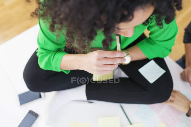 Businesswoman sitting on desk — Stock Photo