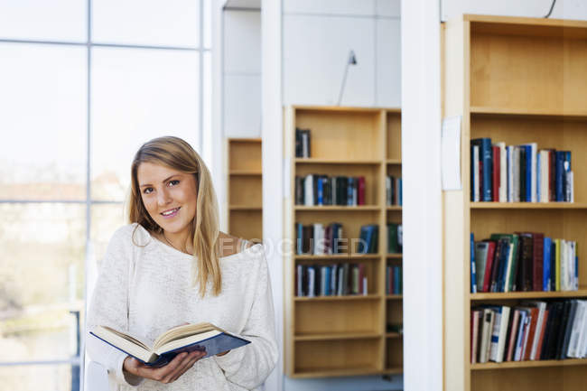 Young woman holding book — Stock Photo