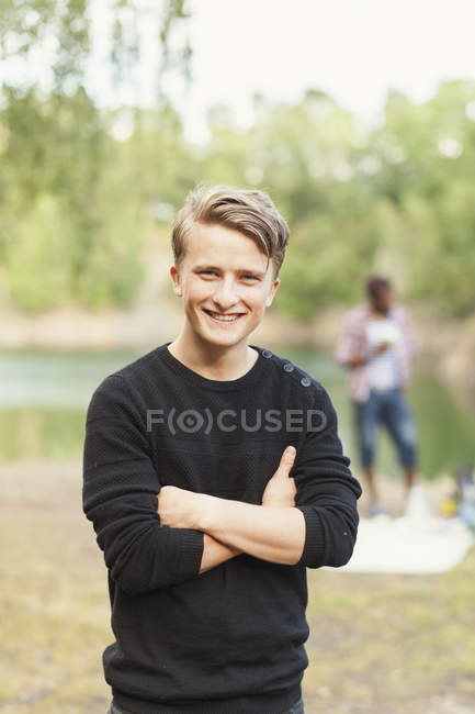 Happy man standing arms crossed — Stock Photo
